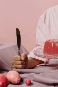 Close-up of hand holding ice cream on table