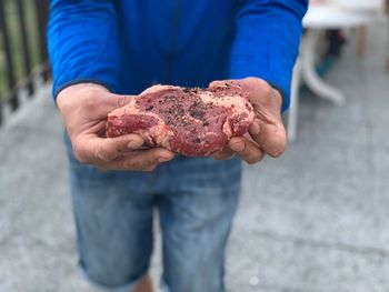 Midsection of man holding ice cream