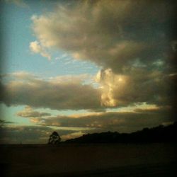 Scenic view of landscape against cloudy sky