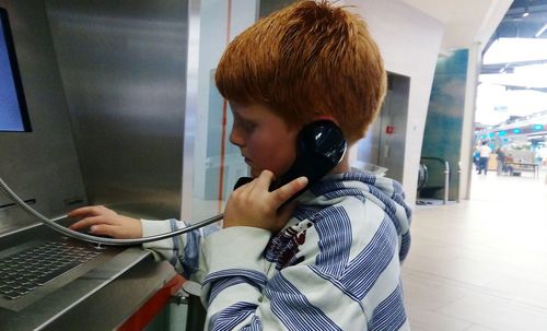 Portrait of boy using mobile phone