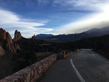 Road by mountain against sky