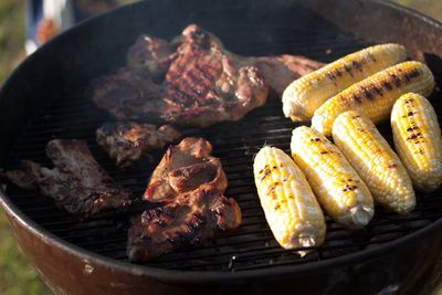 Close-up of meat and corn on barbecue grill