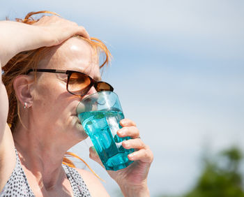 Close-up of woman drinking water bottle