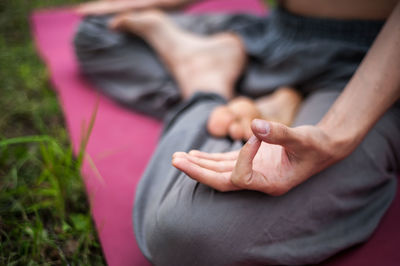 Low section of woman lying on bed