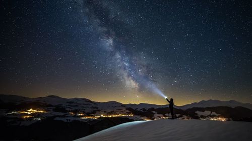 Scenic view of mountains against sky at night