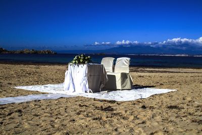 Scenic view of beach against blue sky