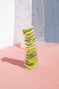 Close-up of stack on table against wall