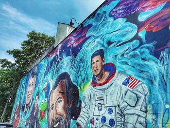 Low angle view of people on graffiti