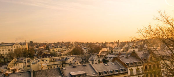 High angle view of buildings in city at sunset
