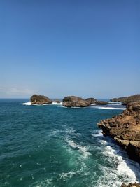 Scenic view of sea against clear blue sky