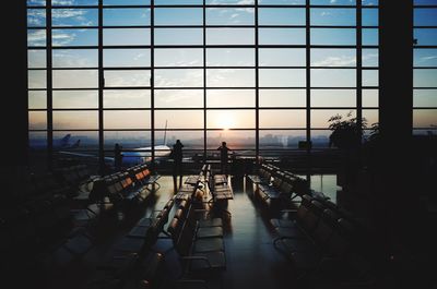 Silhouette people at airport waiting area