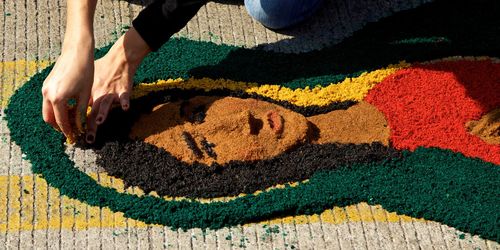 Woman making female art on footpath