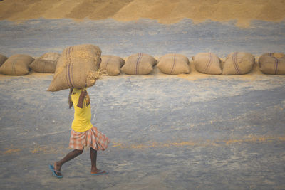 Rear view of woman walking on shore