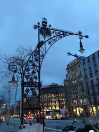 Low angle view of illuminated street light against sky