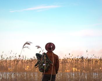 Rear view of man standing against sky