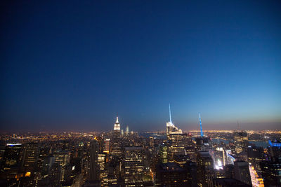 High angle view of buildings lit up at night