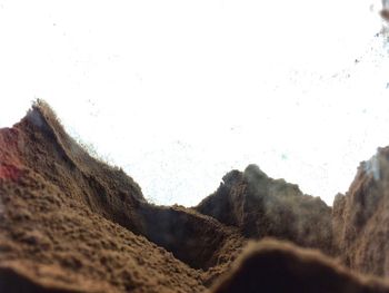 Close-up of sand against clear sky