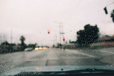 Road seen through wet car window