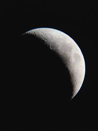 Low angle view of half moon against sky at night