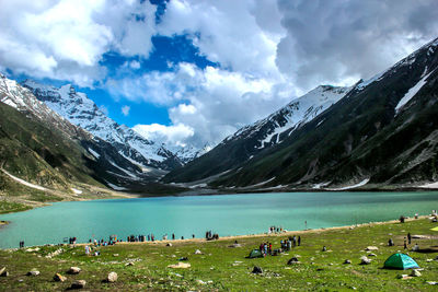 Scenic view of lake by mountains against sky