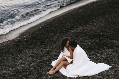 High angle view of woman sitting on beach