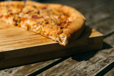 High angle view of pizza on cutting board