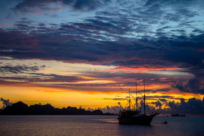 Boat in sea at sunset