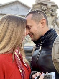 Portrait of couple kissing outdoors