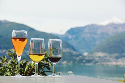 Close-up of beer on table against mountains