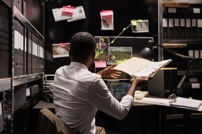 Side view of man working in office