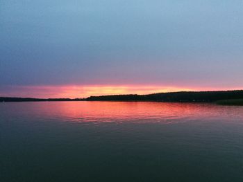 Scenic view of lake against romantic sky at sunset