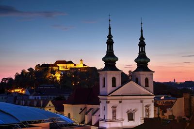 View of buildings in city at sunset