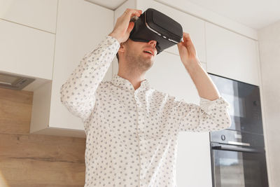 Man wearing virtual reality simulator at home