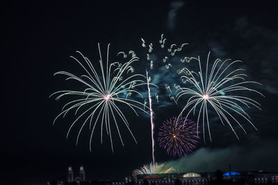 Low angle view of firework display at night