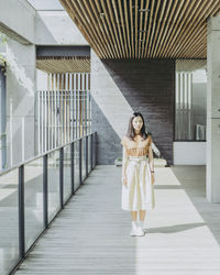 Young woman standing on hardwood floor