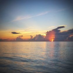 Scenic view of sea against romantic sky at sunset