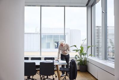 Smiling businessman in boardroom