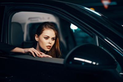 Thoughtful woman sitting in car