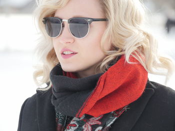 Close-up of young woman with blond hair wearing sunglasses