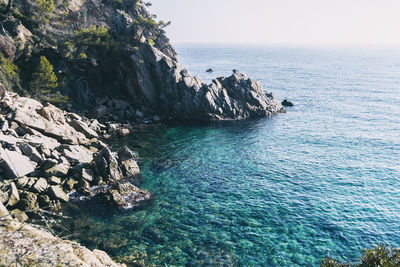 Scenic view of rocks in sea against sky