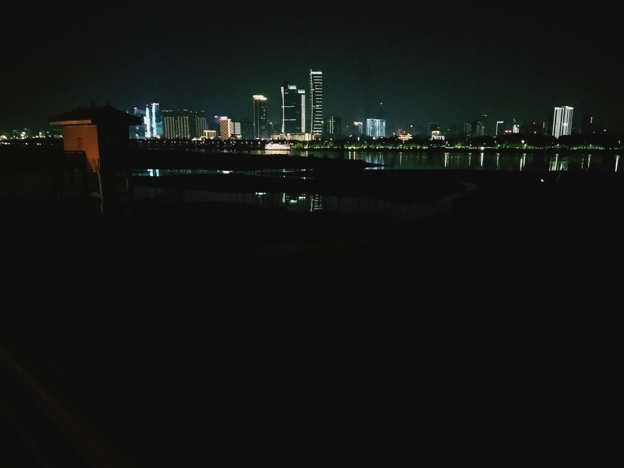 ILLUMINATED BUILDINGS IN CITY AT NIGHT