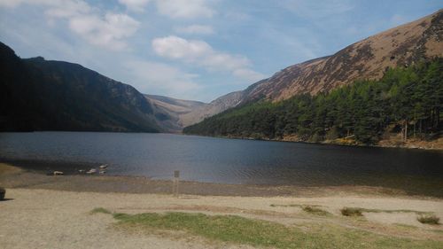 Scenic view of lake and mountains against sky