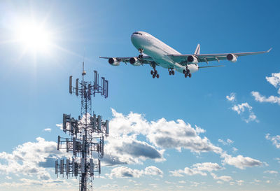 Low angle view of airplane flying against sky