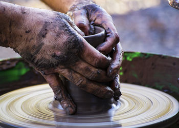 Close-up of man working in mud