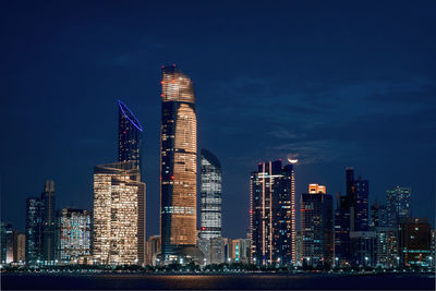 Illuminated skyscrapers in city at night