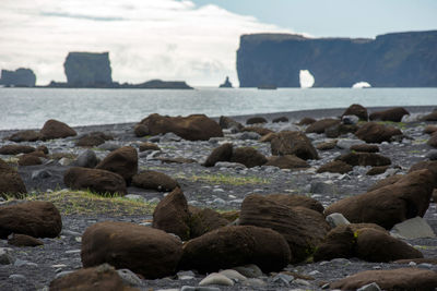 Rocks on beach against sky