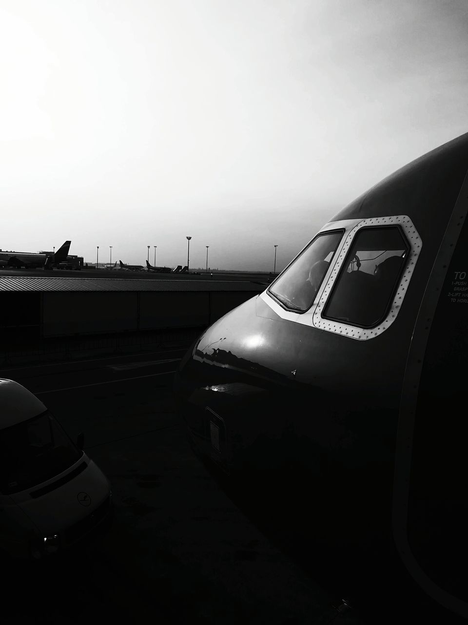 CLOSE-UP OF AIRPLANE ON RUNWAY AGAINST SKY