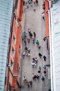 High angle view of people walking on street amidst buildings in city