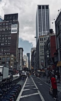 City street and buildings against sky