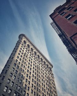 Low angle view of building against cloudy sky